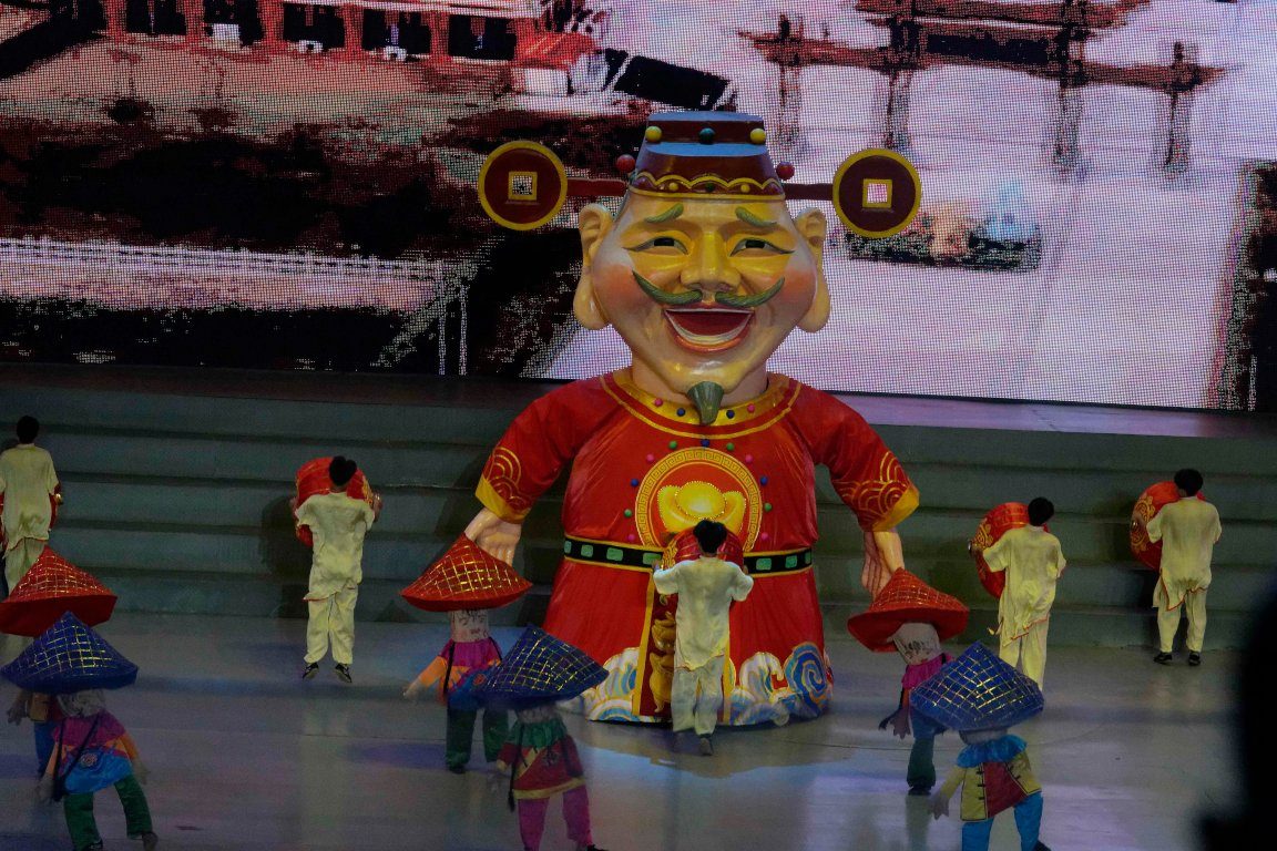 Performers in conical hats on a festival stage in Xiamen